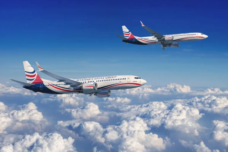 Two Aviation Capital Group Boeing 737 aircraft flying above the clouds under a clear blue sky, showcasing their modern fleet and branding.